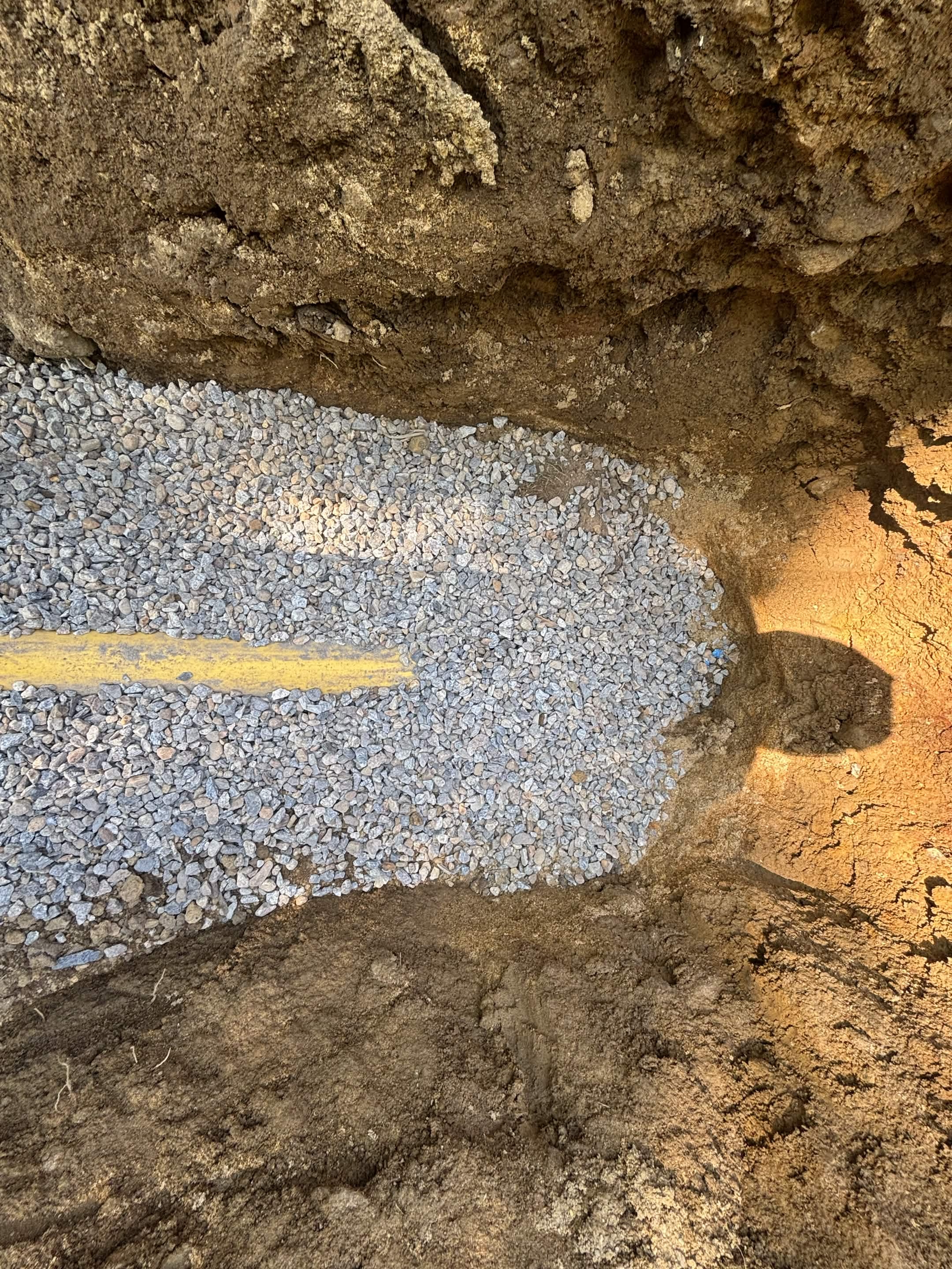 Drainage trench backfilled after pipe installation